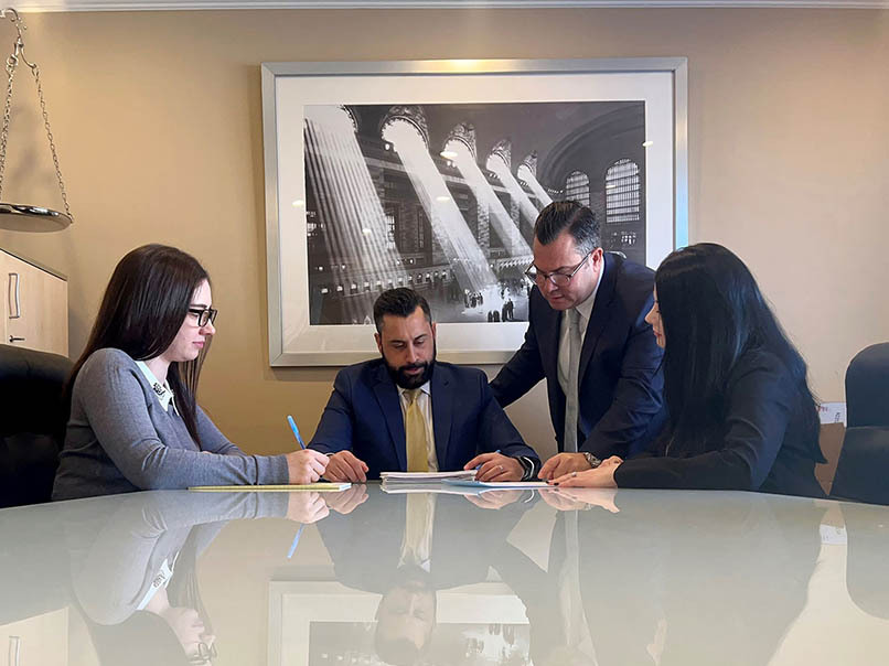 Landlord-tenant lawyer consulting with clients to review lease and rental agreement issues.